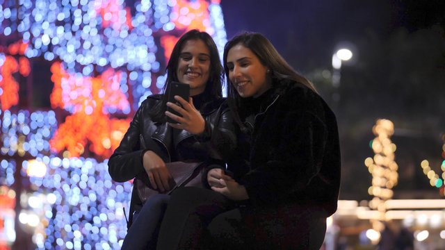 Friends video calling in the city