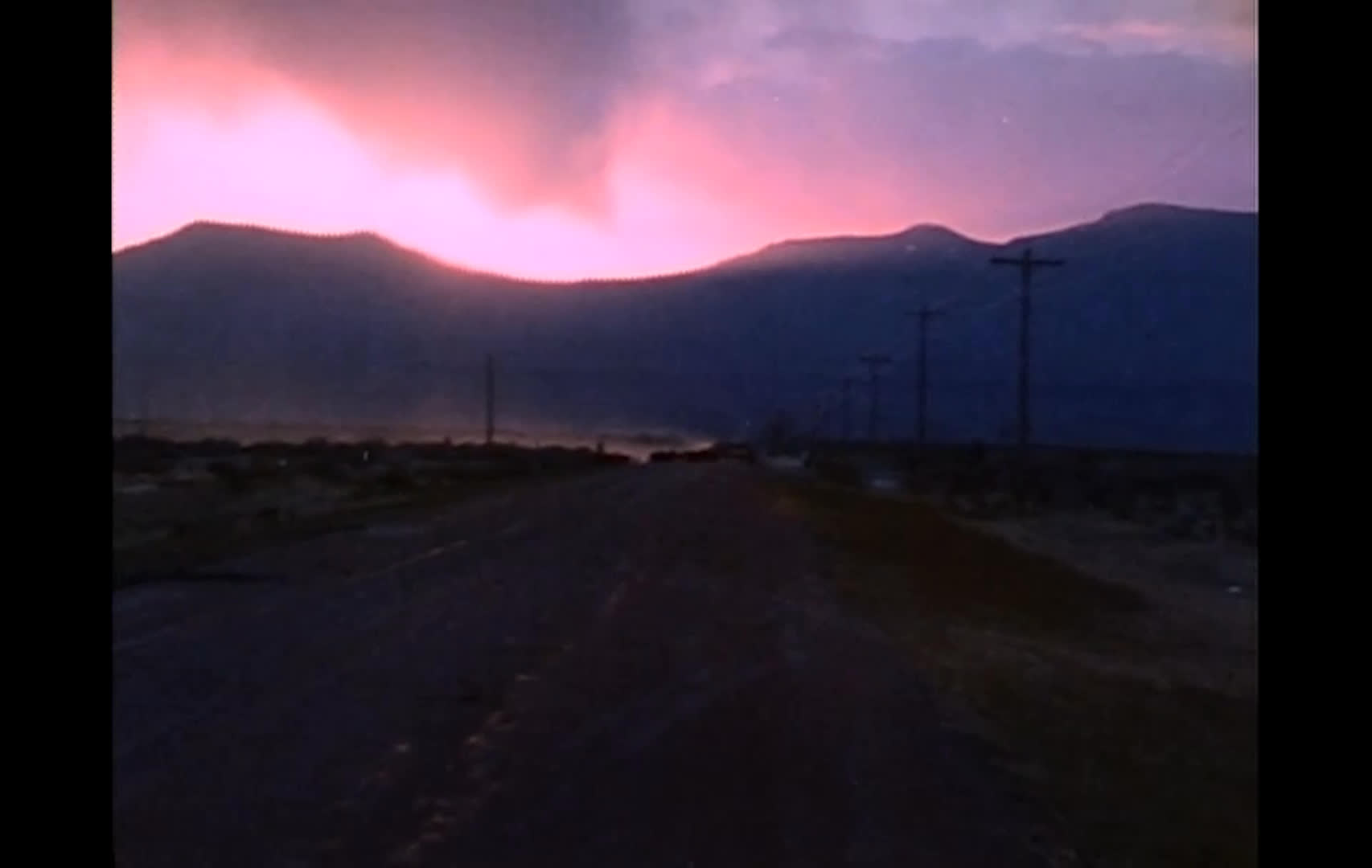 A lone horseback rider fades into a rural landscape as a dark road leads toward mountains beneath a vivid pink sunset. The title cards introduce a modern range war fought through words in courtrooms and conference rooms rather than with guns.