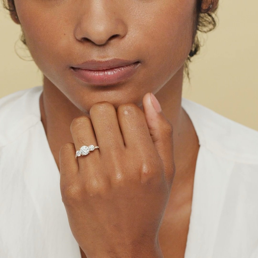 The Three Stone | Round Brilliant | Platinum | bandAccent: Pavé | caratWeight: other | sideStoneCarat: 0.25ct | sideStoneShape: Round Brilliant | diamondOrientation: vertical