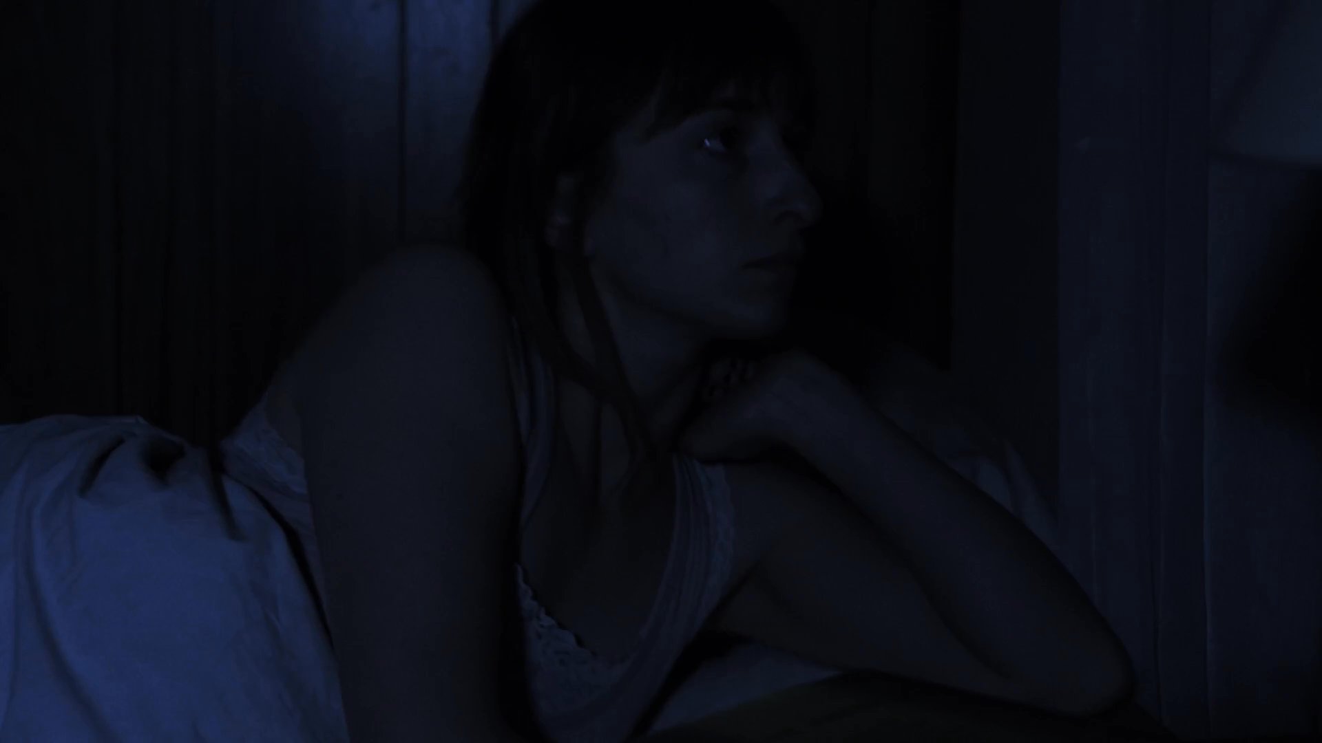 A woman experiences restless insomnia in her bedroom during the night before transitioning to a quiet morning in her kitchen. She eventually prepares a meal while alone in the early light.