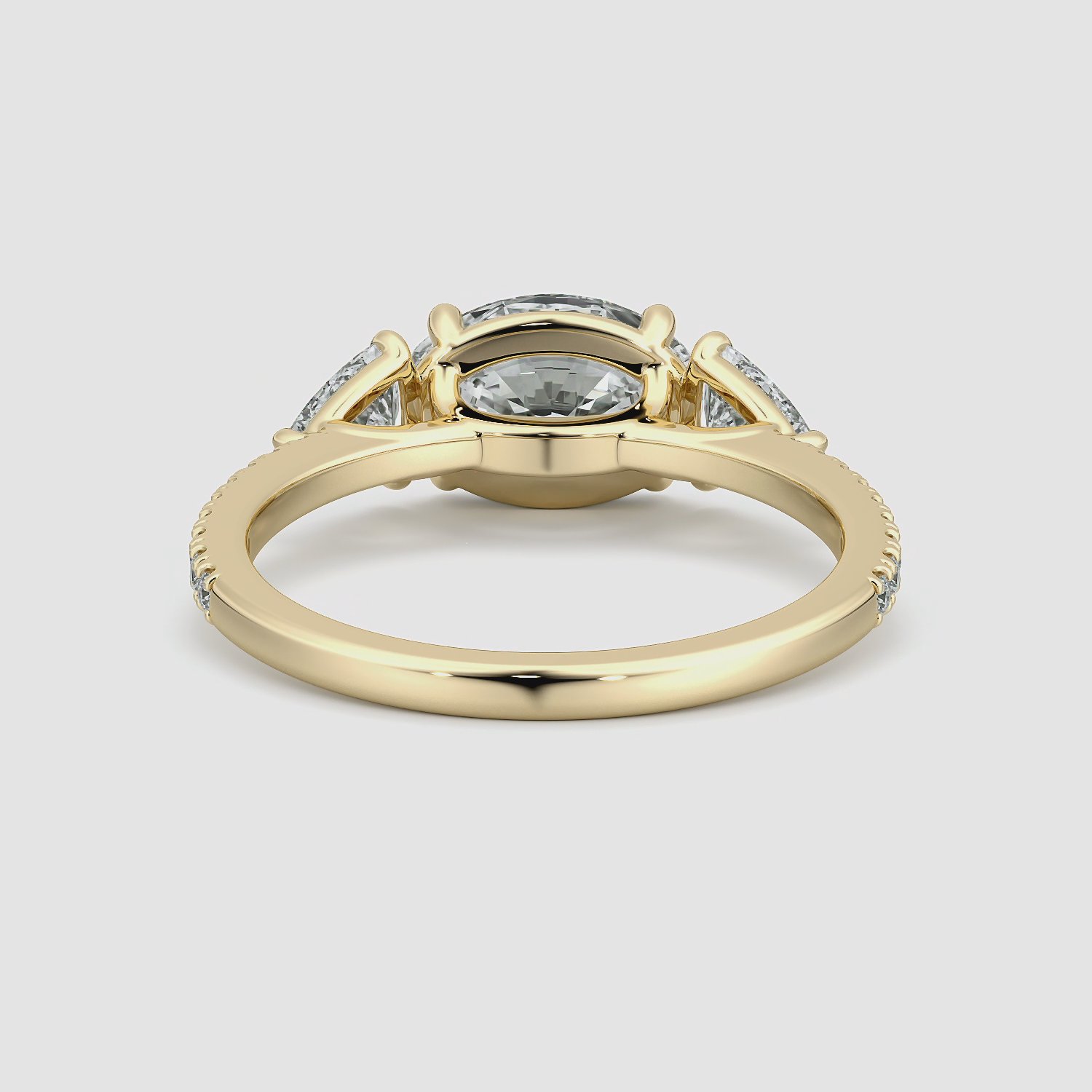 The Three Stone | Oval | 18k | Yellow Gold | bandAccent: Pavé | diamondOrientation: horizontal | sideStoneCarat: 0.25ct | sideStoneShape: Trillion | caratWeight: other