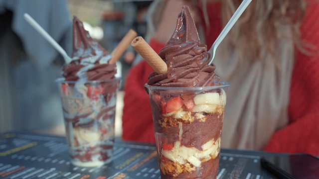 Plastic cups filled with chocolate ice cream and fruit