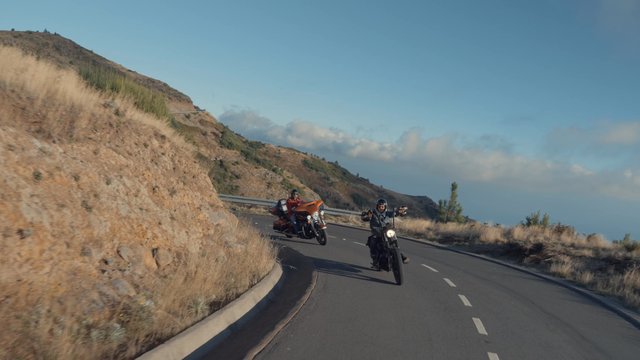 Motorcyclists coming around a curve in the road