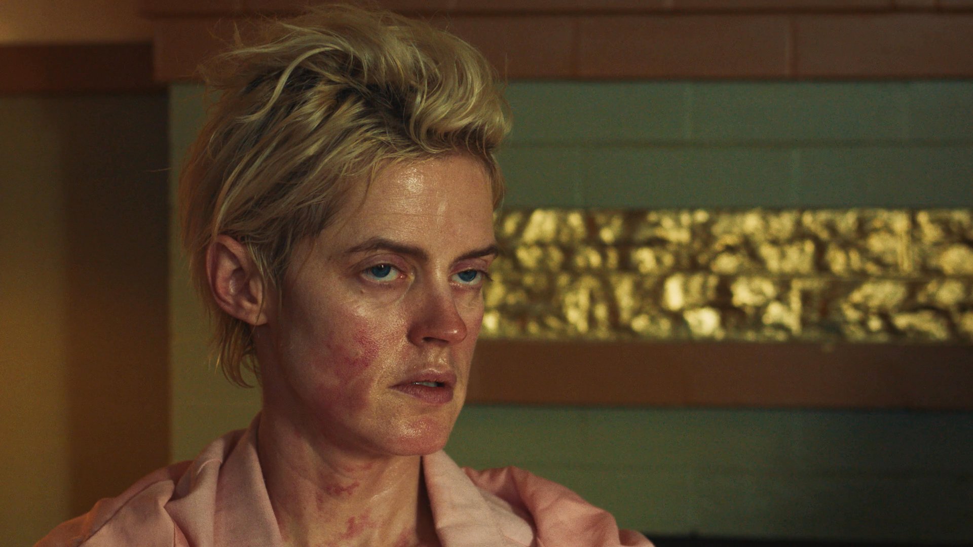 Three individuals engage in a tense, intimate conversation within a residential setting. The emotional dialogue highlights nuanced facial expressions and shifting social dynamics between the characters.