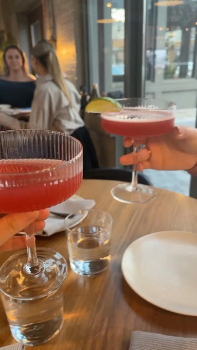 REDD - Cheers with the mocktail "Cosmo." - New American Near Me - Rochester, New York