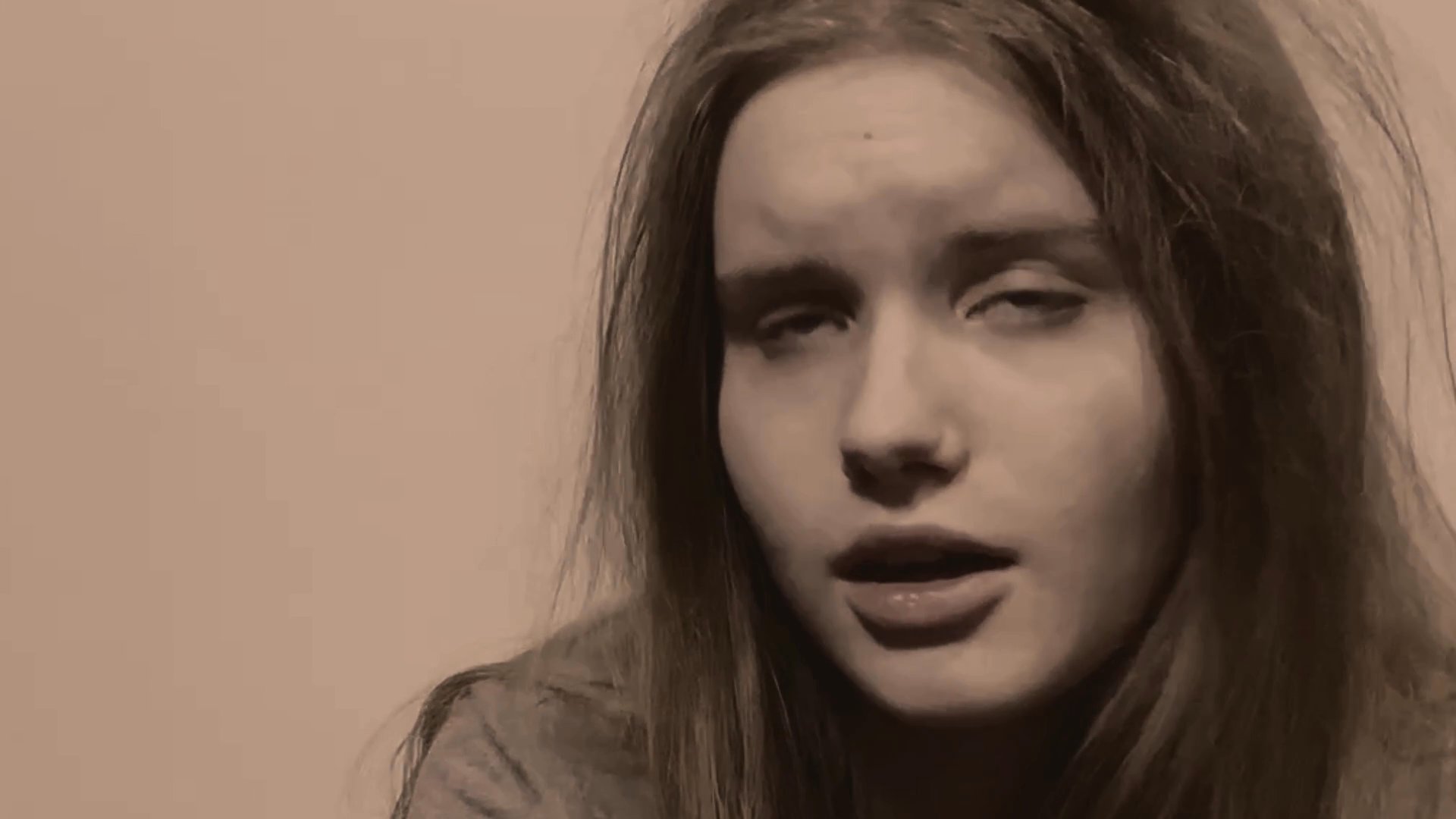 A young woman delivers an expressive, emotionally charged monologue directly to the camera. Her facial expressions shift dynamically as she engages in a persuasive or theatrical narrative.