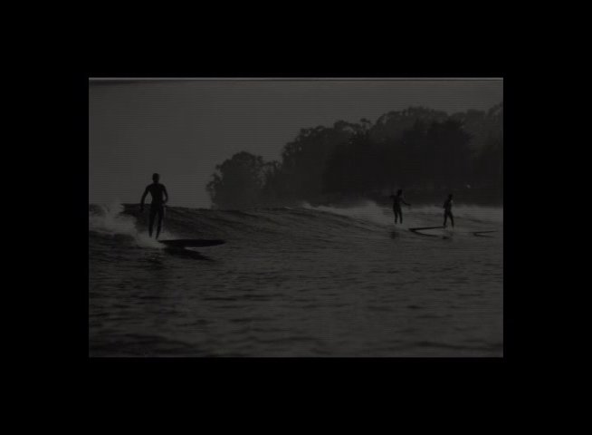 A collection of archival black-and-white photographs transitions into contemporary color footage of surfers and a classic station wagon. The sequence highlights the evolution of surf culture and the enduring nature of the coastal sport.