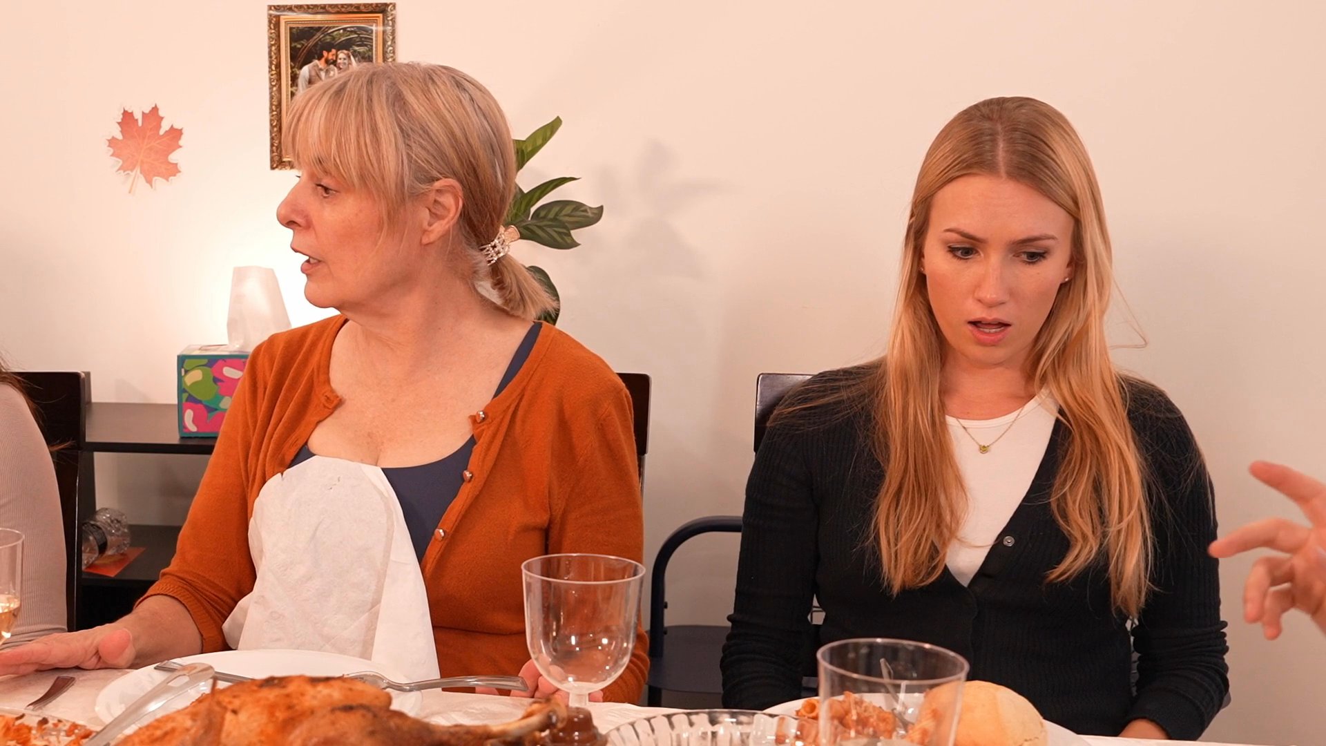 A diverse group of family and friends gather for a festive holiday dinner featuring a roasted turkey and various side dishes. The group shares a celebratory toast and engages in lively conversation during the meal.