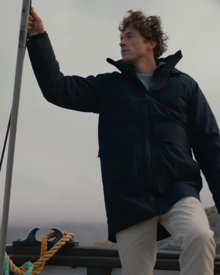 Video montage of man in the Anchorage Down Jacket on a boat in Norway