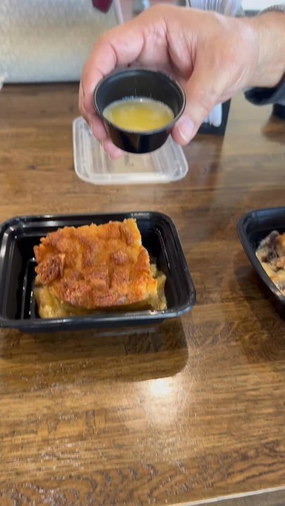 Gulf Coast Bread Pudding - Creole bread pudding getting drizzled in rum caramel sauce - Desserts Near Me - Houston, Texas
