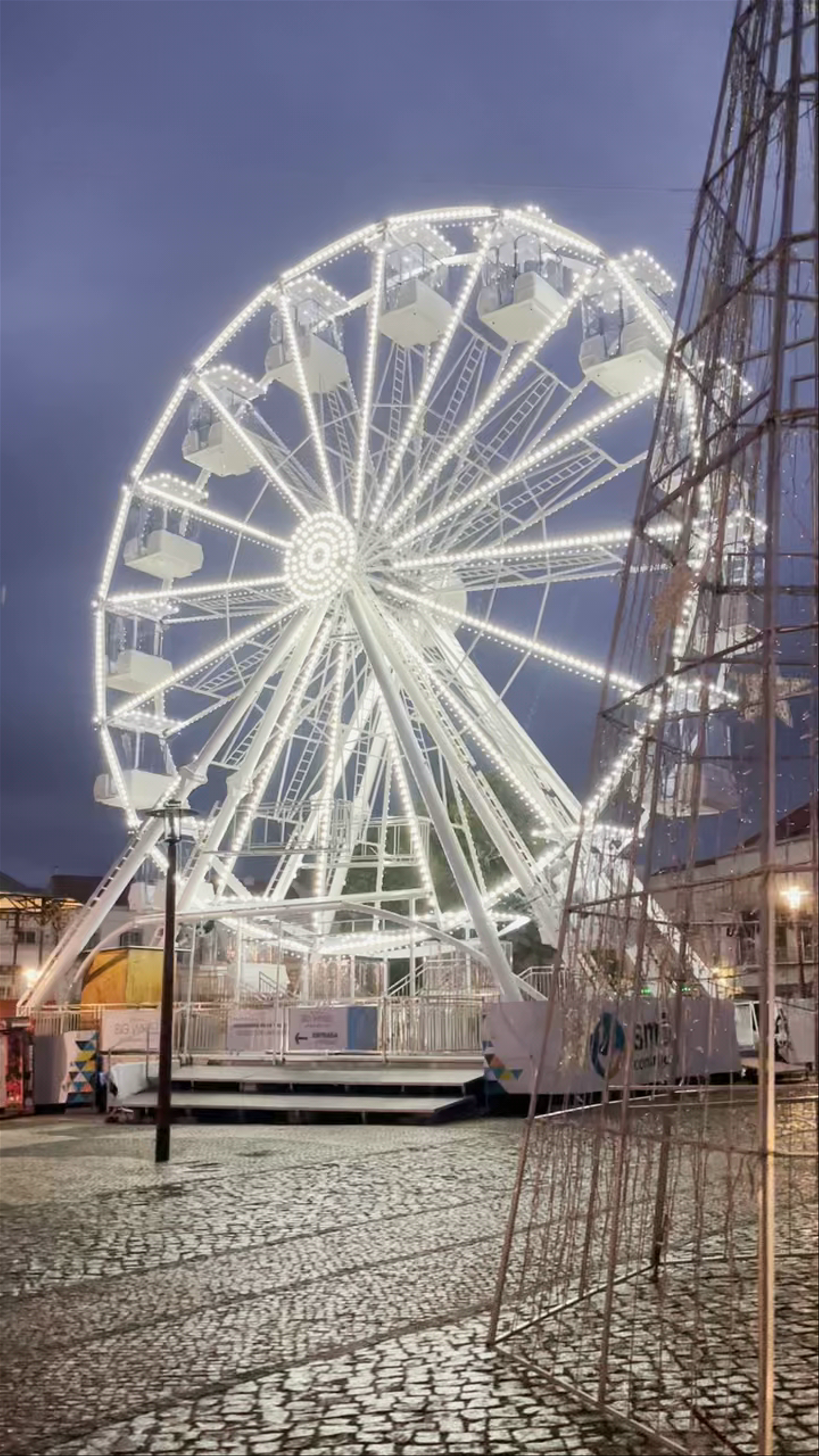 Illuminated Ferris Wheel at Nazaré Praia do Norte at Twilight