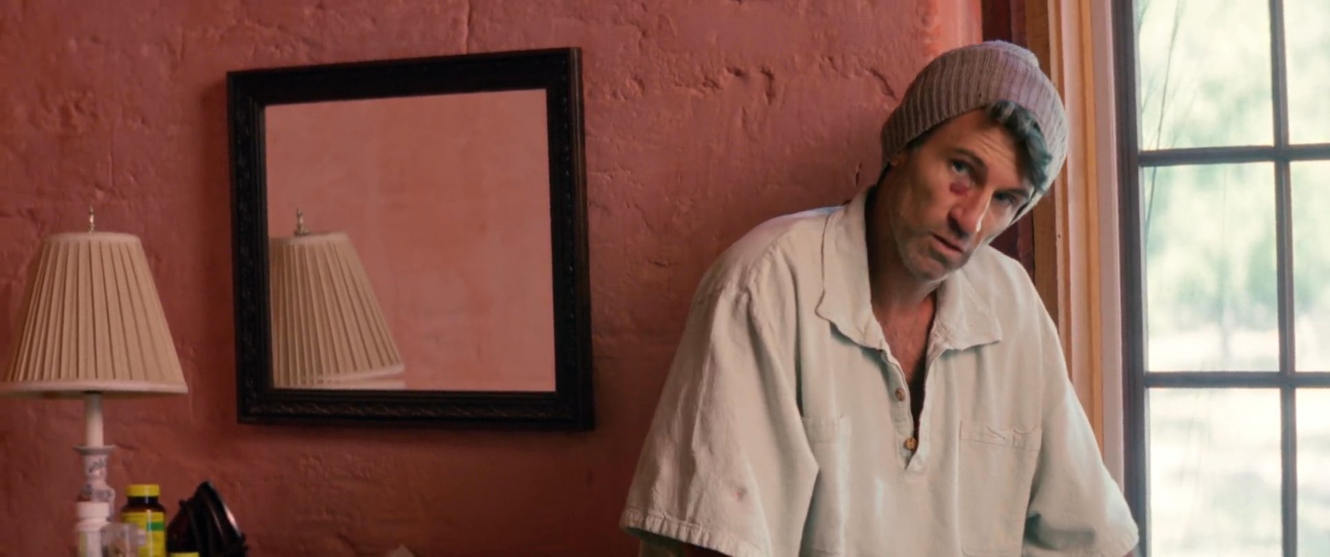 Two men engage in a focused conversation within a domestic environment. The exchange highlights a dynamic interaction between the two subjects.