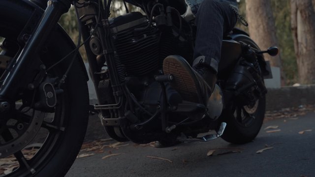 A motorcyclist bringing his vehicle to a halt