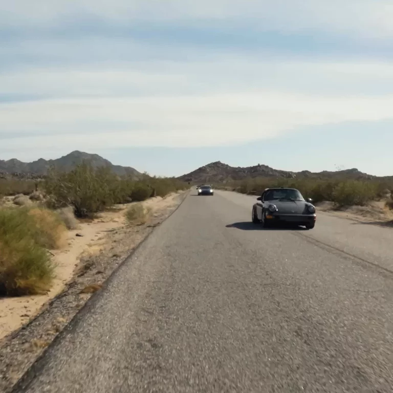 Vintage cars driving on road in Joshua Tree