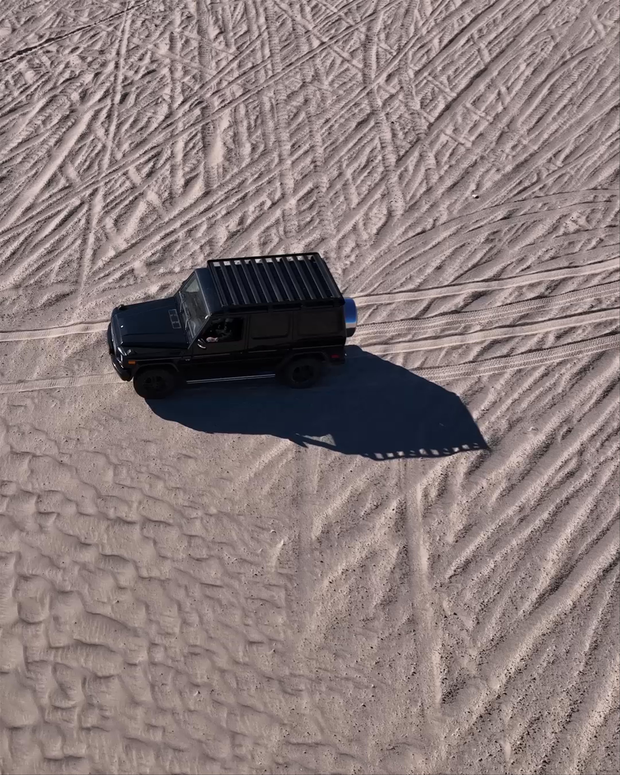 Video montage of man and woman wearing AETHER sunglasses in California sand dunes