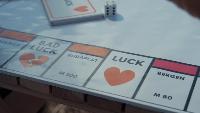 A guy moves a piece a board game he’s playing with his partner