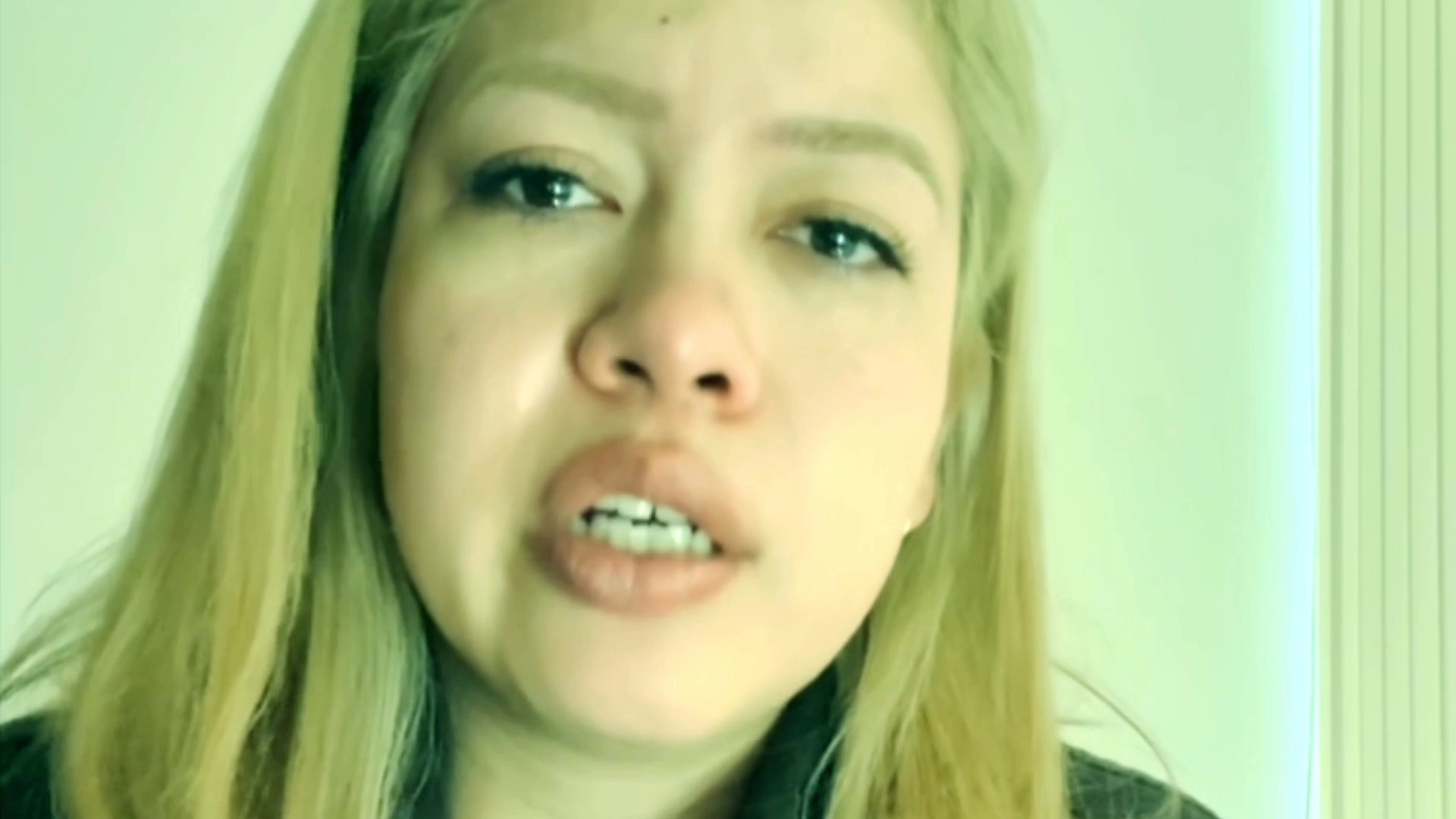 A woman shares a vulnerable and emotionally charged reflection while facing the camera. Her facial expressions convey visible distress and intense personal feeling.