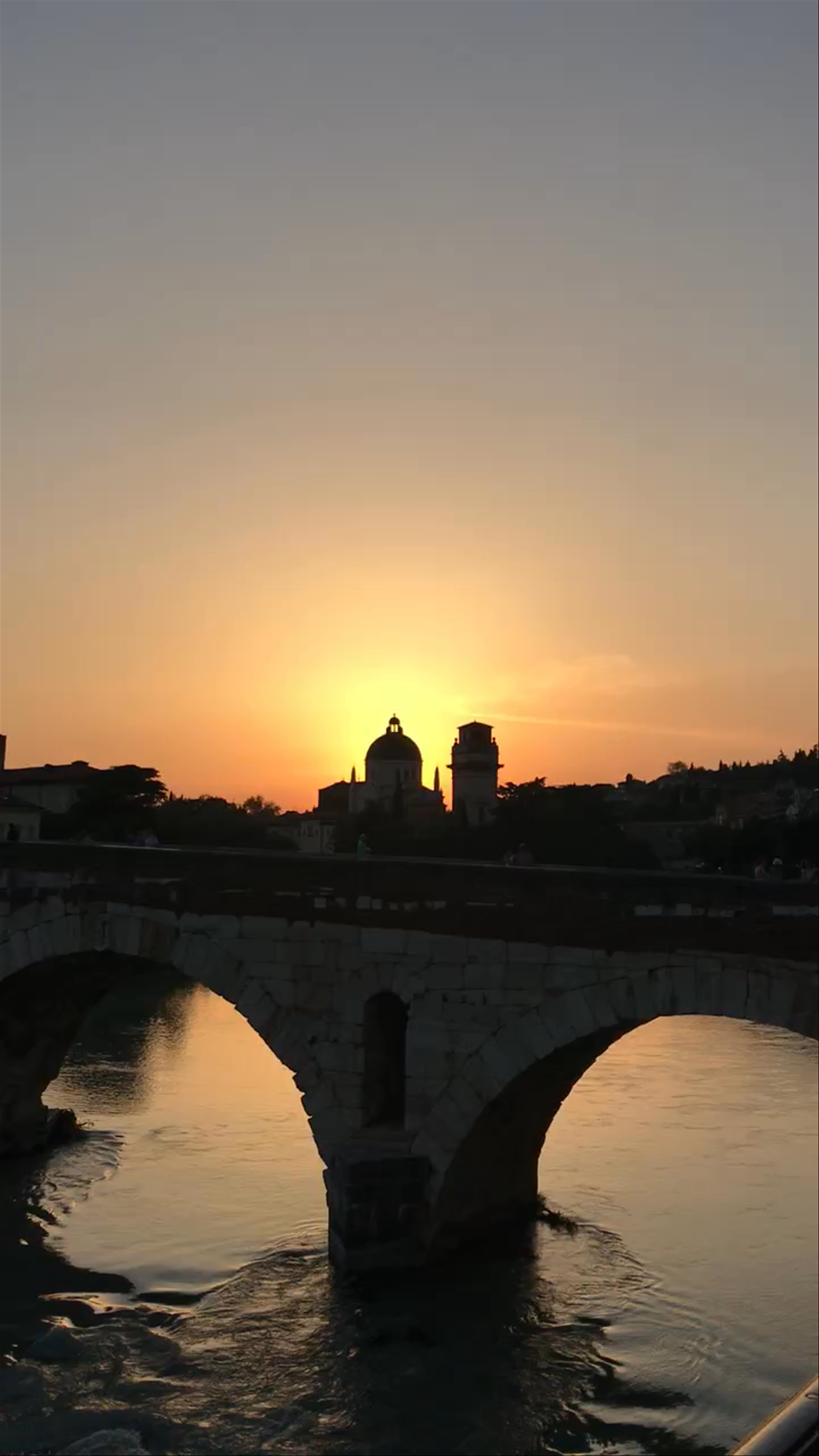 Sunset Over Verona's Historic Ponte Pietra and River Scene