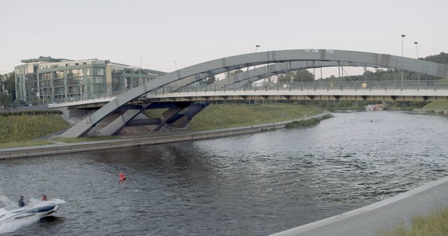 Speed boat under Mindaugas Bridge in Vilnius 
