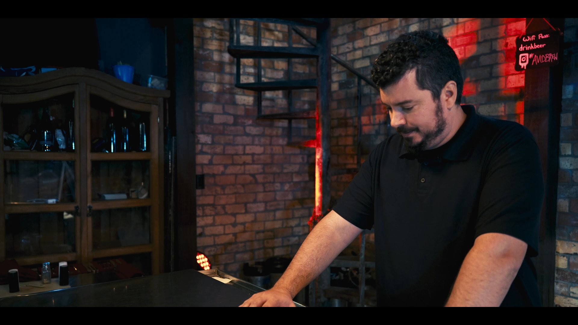 Two men engage in a professional conversation within a contemporary, brick-walled interior space. The scene transitions to an aerial perspective showcasing a sprawling urban cityscape with green spaces and high-rise buildings.