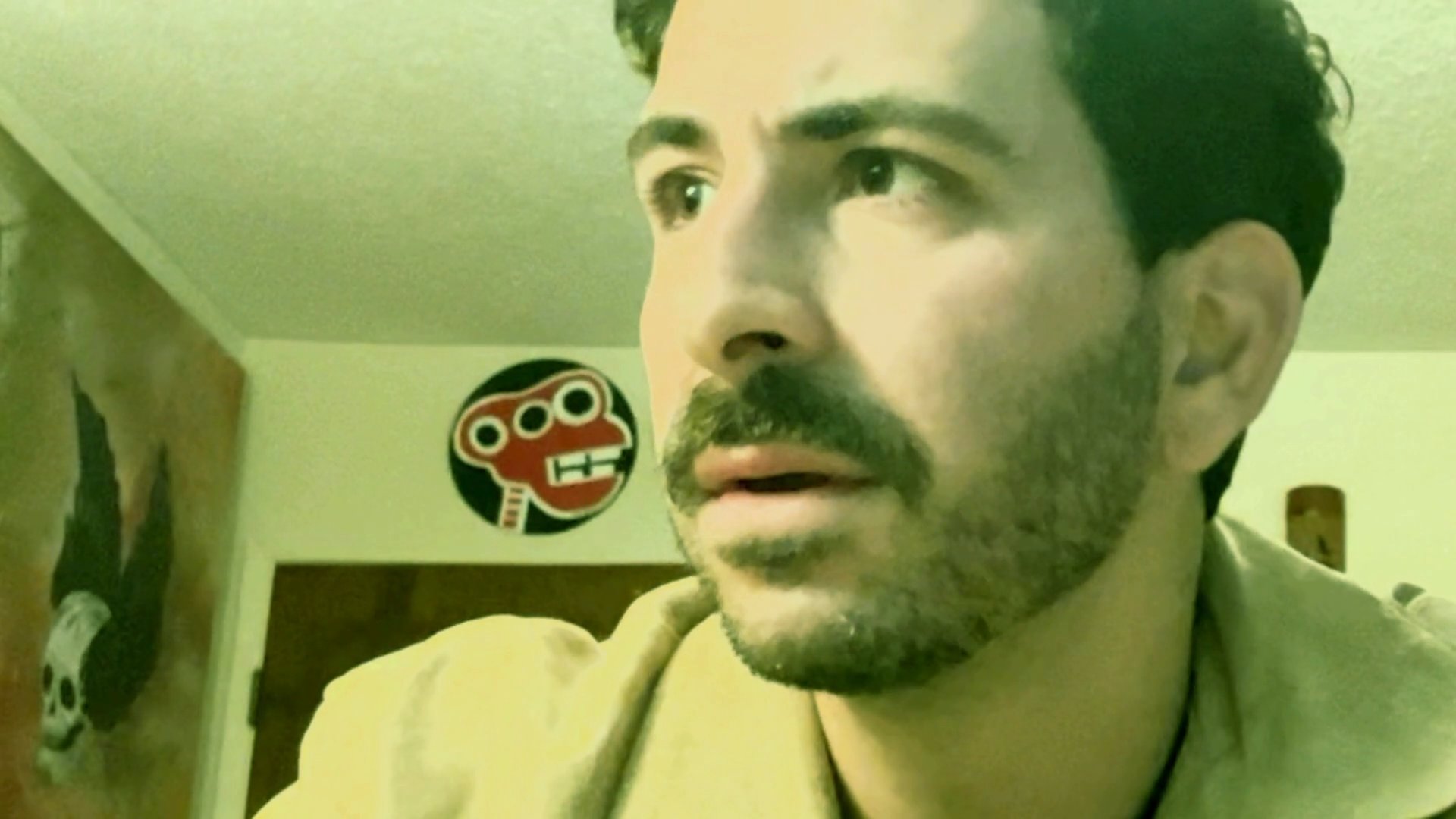 A man delivers an expressive and emotive monologue while looking off-camera, exhibiting various facial expressions and shifts in focus.