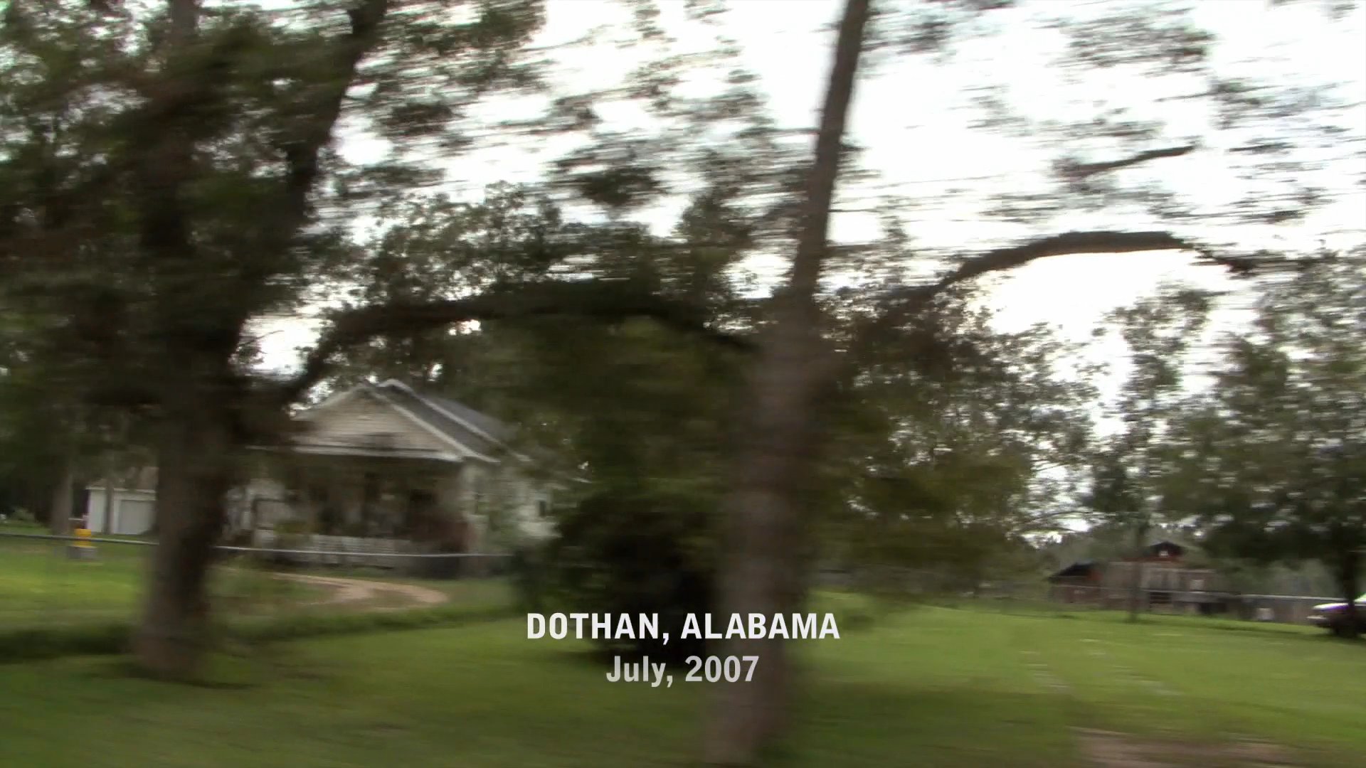 A view of residential houses and neighborhood landscapes passes by from a moving vehicle in Dothan, Alabama, during July 2007.