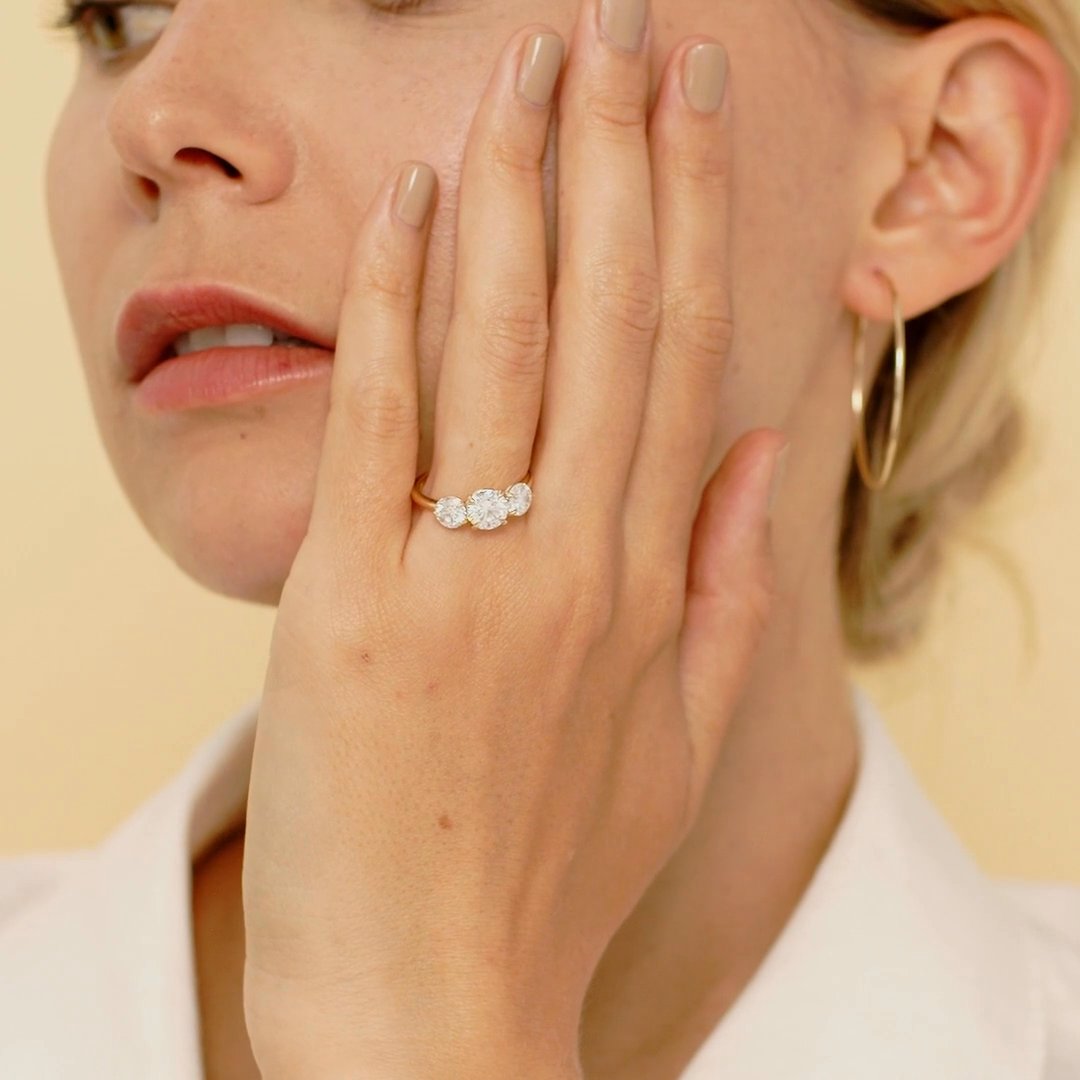 The Three Stone | Round Brilliant | Platinum | bandAccent: Plain | caratWeight: other | sideStoneCarat: 0.50ct | sideStoneShape: Round Brilliant | diamondOrientation: vertical