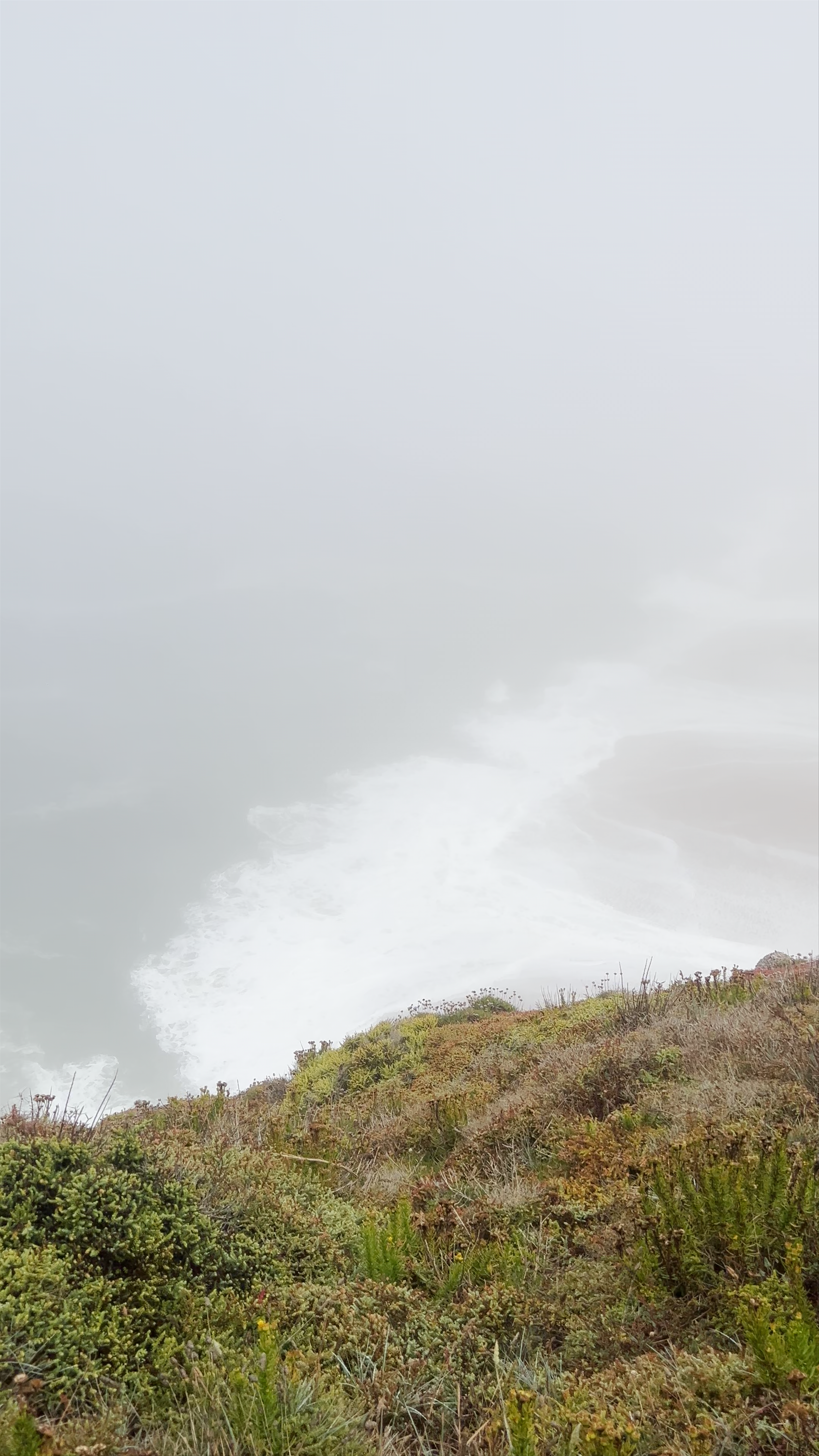 Misty Coastal Cliffs at Praia da Nazaré, Portugal