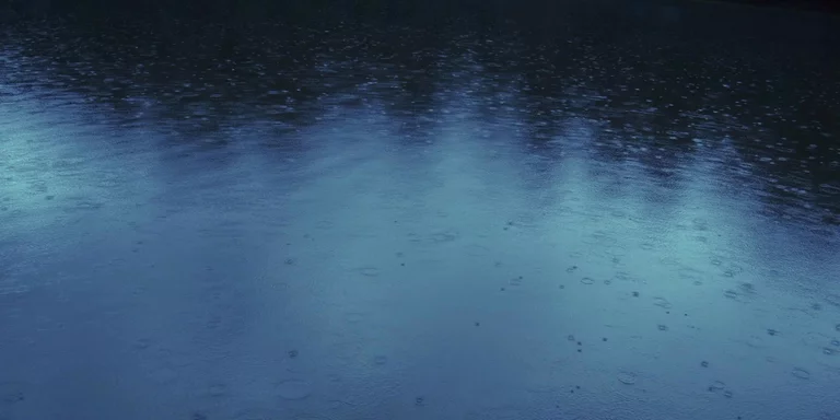 Rain falling on blue lake