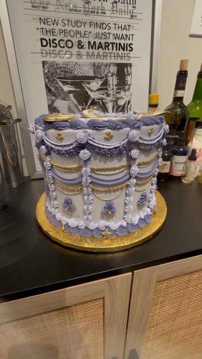 Lydia’s - It's a purple and gold round cake-with gold moons on the top. It says "happy birthday Amia" in icing on the top of the cake. - Bakeries Near Me - Saint Charles, Missouri