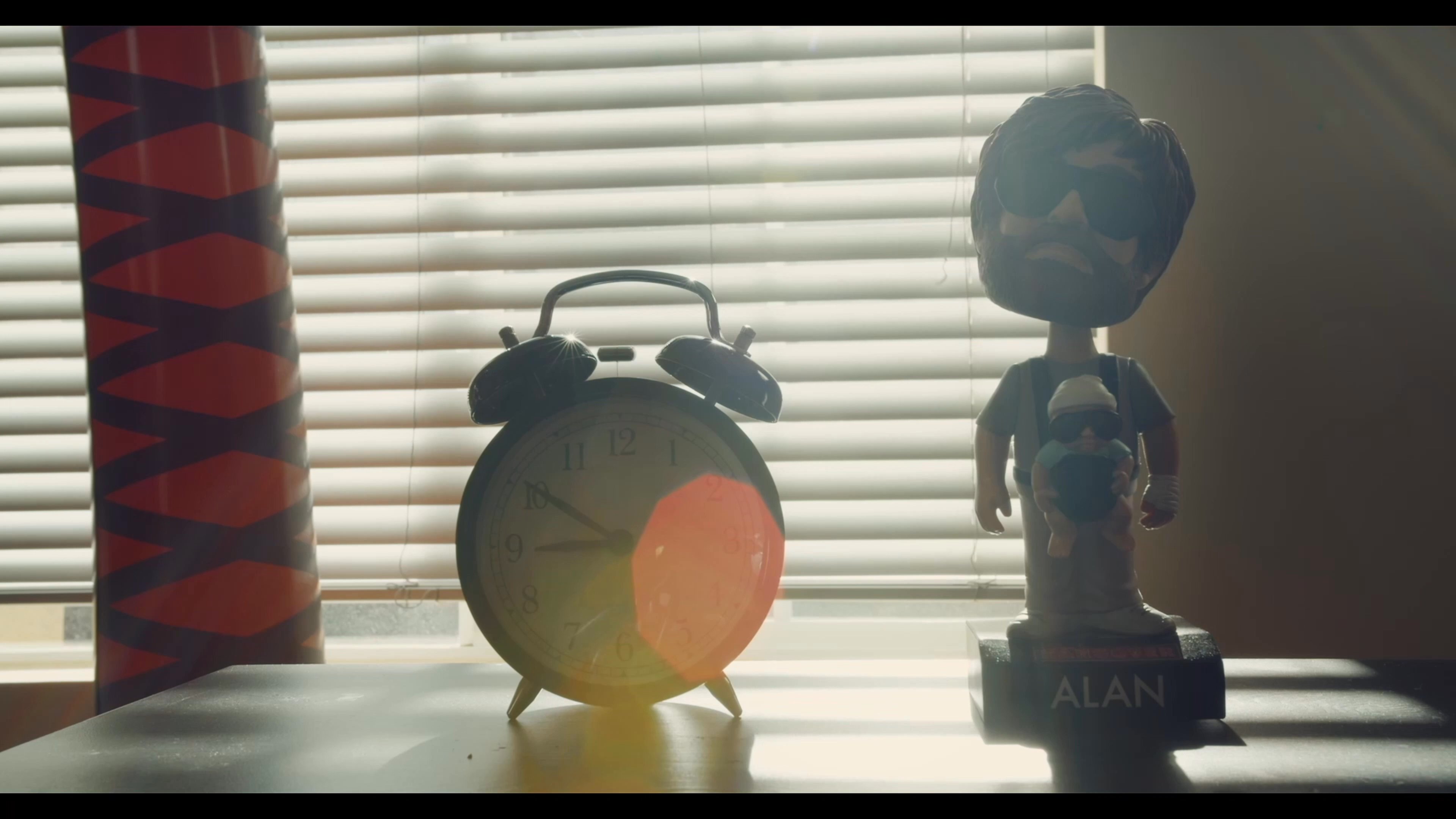 A man wakes up in an inflatable pool positioned in his bedroom. He exits the pool and prepares to begin his day in the home environment.