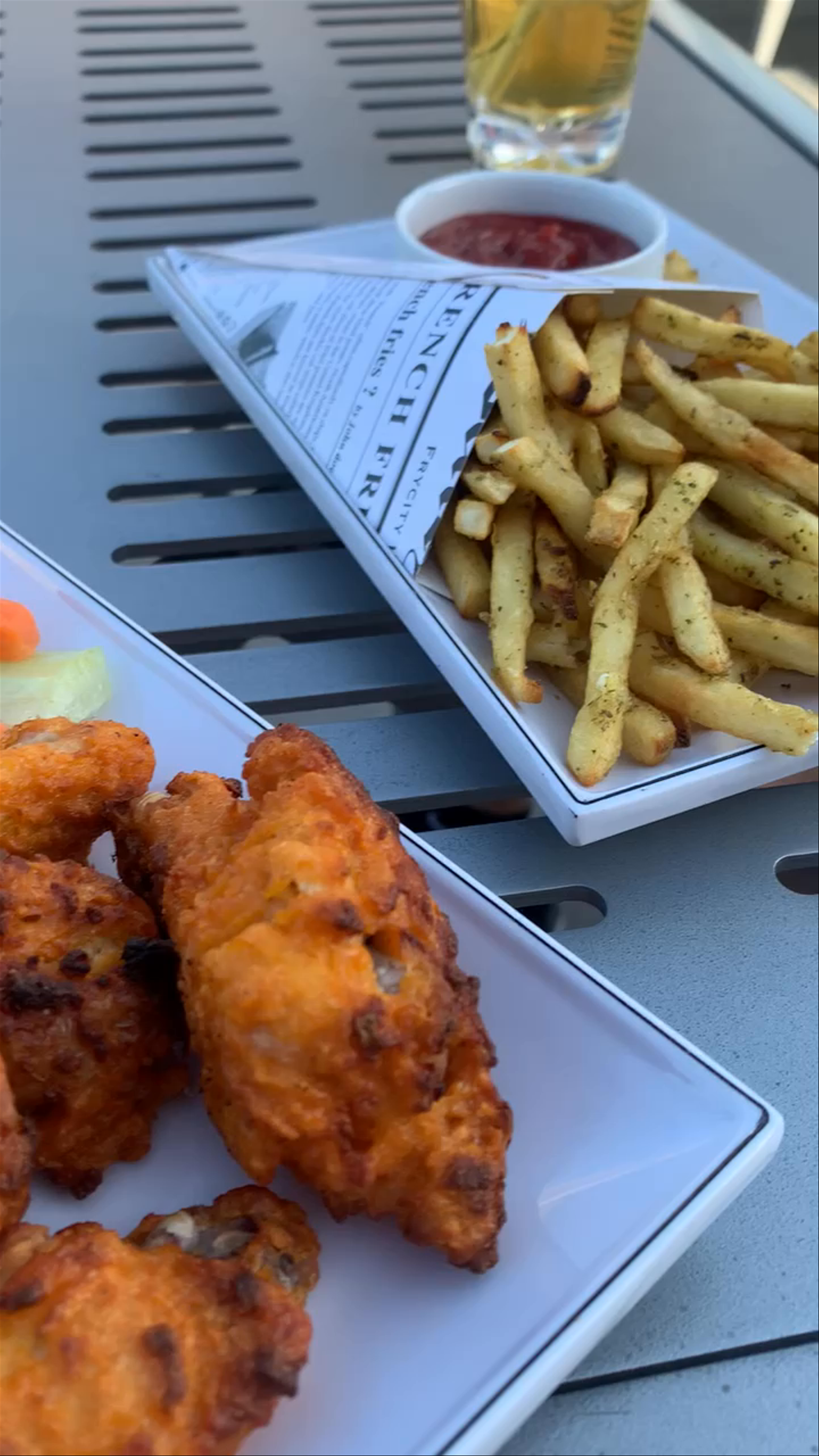 Sunny Urban Bites: Wings and Fries with a Nashville Skyline View