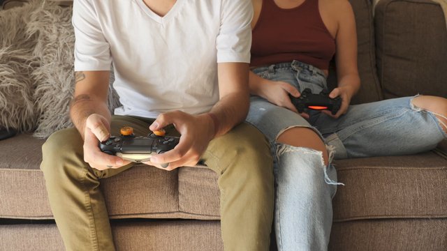 Couple holding gaming controllers