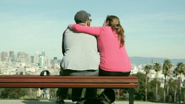 Couple hugging on a bench