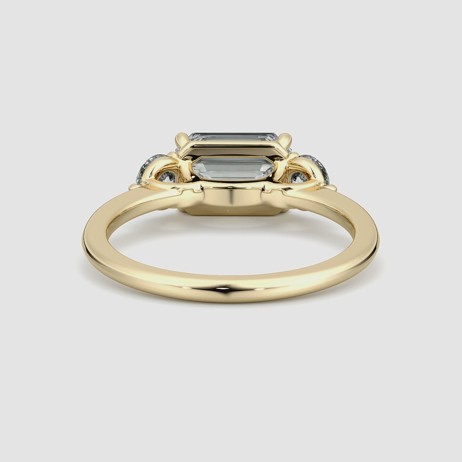 The Three Stone | Emerald | 18k | Yellow Gold | bandAccent: Plain | diamondOrientation: horizontal | sideStoneCarat: 0.25ct | sideStoneShape: Round Brilliant | caratWeight: other