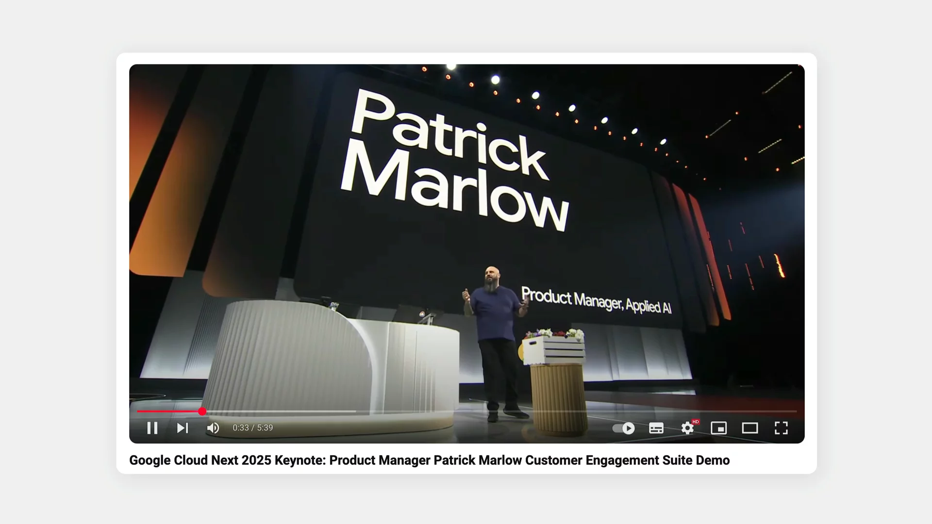 Google Cloud Next 2025 keynote presentation. Product Manager Patrick Marlow stands on stage in front of a large screen displaying an e-commerce website demo for garden products, featuring categories like tools, plants, and landscaping services. Stage is set with modern lighting and conference branding.