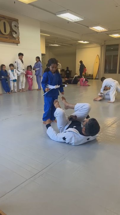 Jiu-Jitsu League - Coach Juan teaching child - Martial Arts Near Me - Long Beach, California