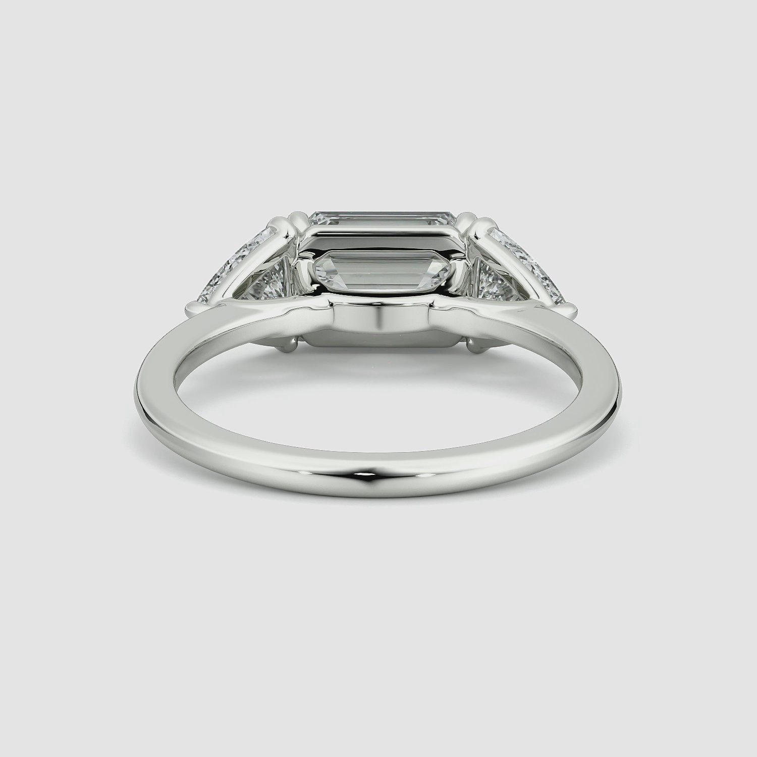 The Three Stone | Emerald | Platinum | bandAccent: Plain | diamondOrientation: horizontal | sideStoneCarat: 0.50ct | sideStoneShape: Trillion | caratWeight: other