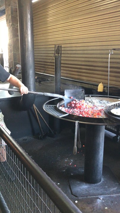 Hard Eight BBQ - Steaks & onions being cooked over hot coals. - Barbeque Near Me - Roanoke, Texas