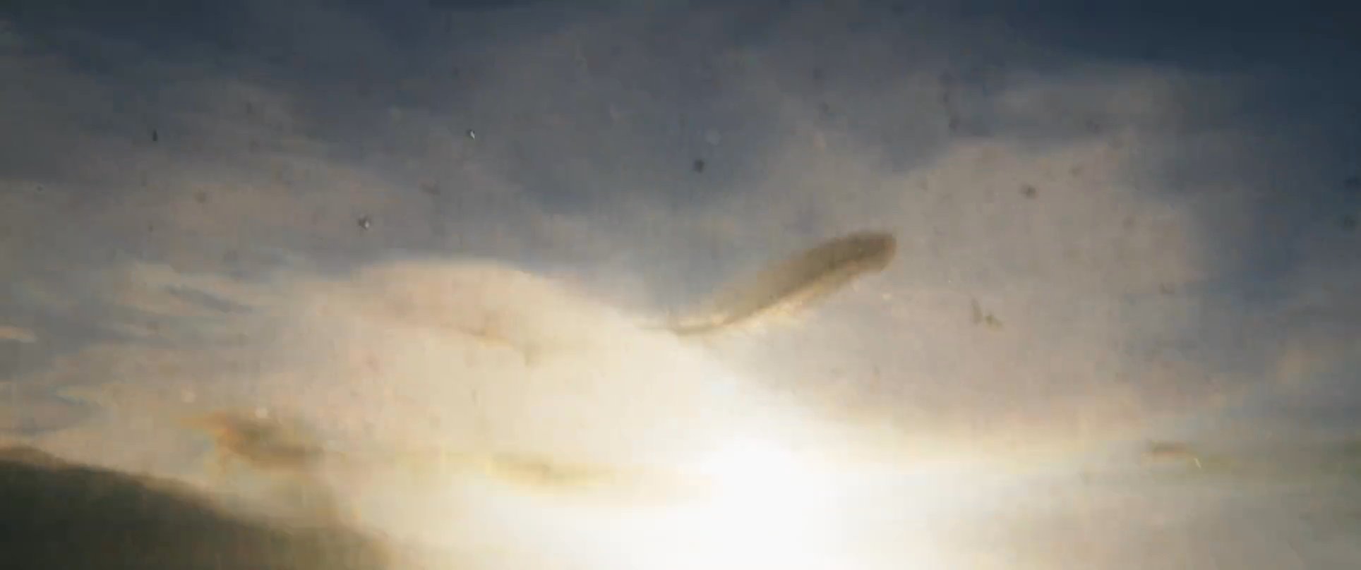 A man experiences a surreal underwater descent and ascent, transitioning between the murky depths of the sea and a solitary presence in a forest landscape.