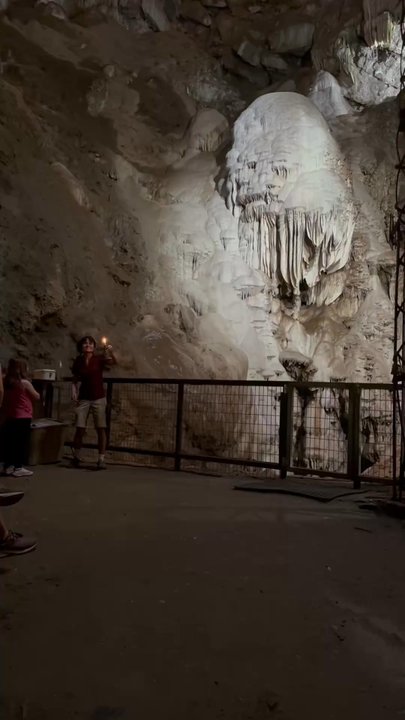 Moaning Caverns Adventure Park - She shows us how dark the cave without lights - just has candles - Amusement Parks Near Me - Vallecito, California