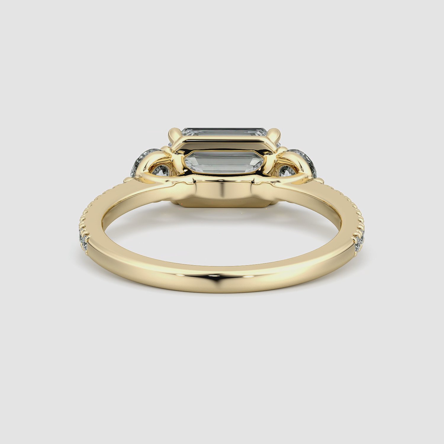 The Three Stone | Emerald | 18k | Yellow Gold | bandAccent: Pavé | diamondOrientation: horizontal | sideStoneCarat: 0.25ct | sideStoneShape: Round Brilliant | caratWeight: other