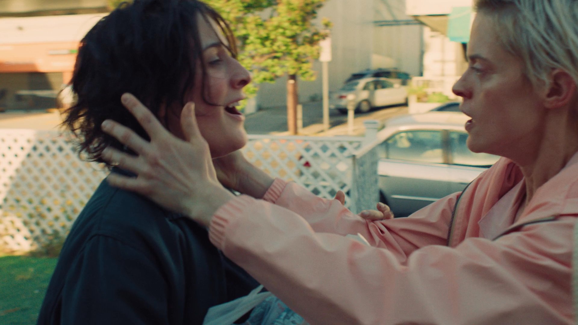 Two individuals engage in a volatile disagreement over a large amount of cash before reconciling with a supportive embrace.