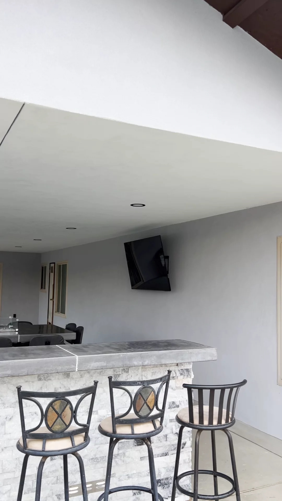 Patio cover with outdoor bar, concrete countertop, stone veneer & built-in lighting