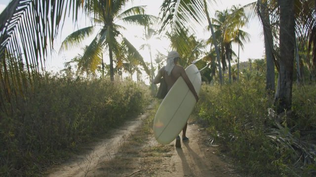 Man walking through a tropical forest