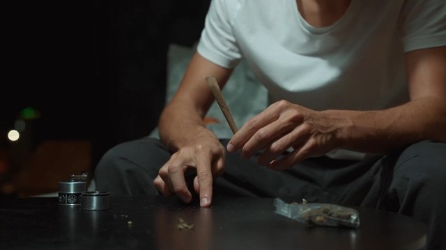 Man rolling marijuana joint