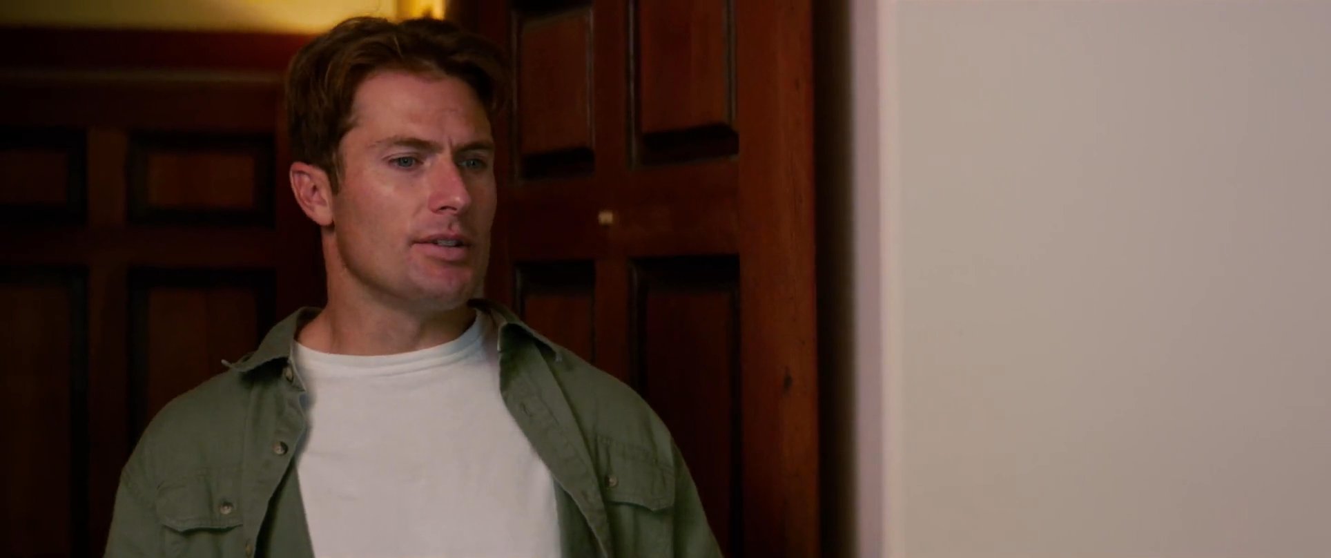Two men engage in a tense conversation, alternating between shots as they exchange dialogue in an interior residential setting.