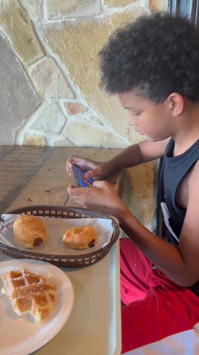 Caffe Promenade - Hungry guy with game on his mind so he multi tasked - Coffee & Tea Near Me - Allen, Texas