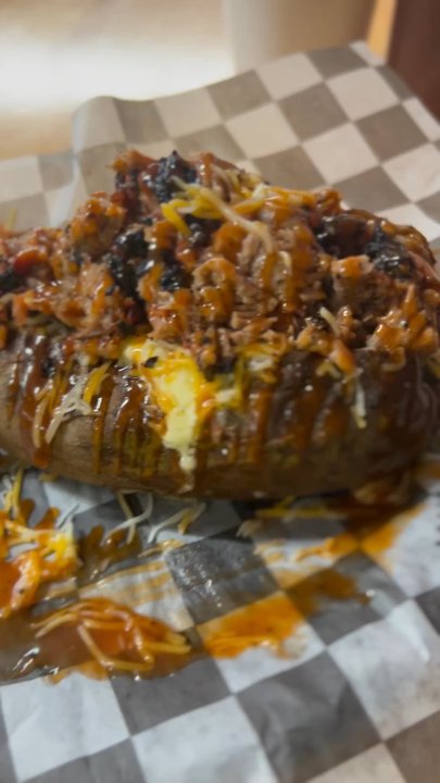 Dee Willie's BBQ - Baked potato with Brisket and cream corn. - Barbeque Near Me - San Antonio, Texas