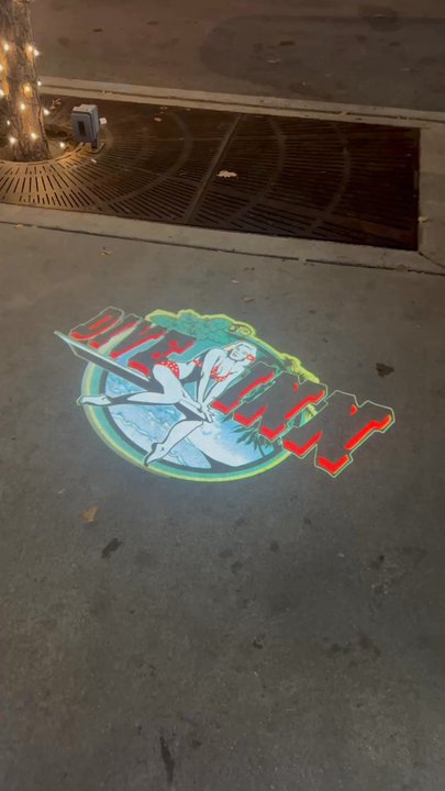 Dive Inn - Dive Inn signage by a moving light; pretty cool!! - Dive Bars Near Me - Denver, Colorado